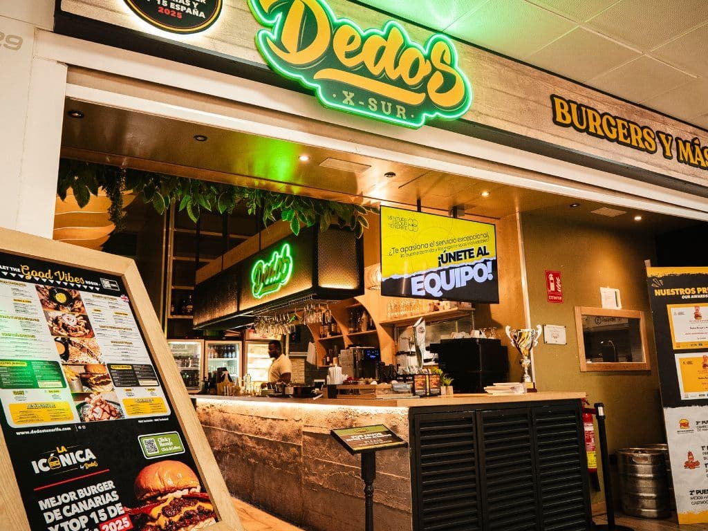 Mostrador de Dedos X-Sur con el rótulo de neón, la carta iluminada y la cocina al fondo